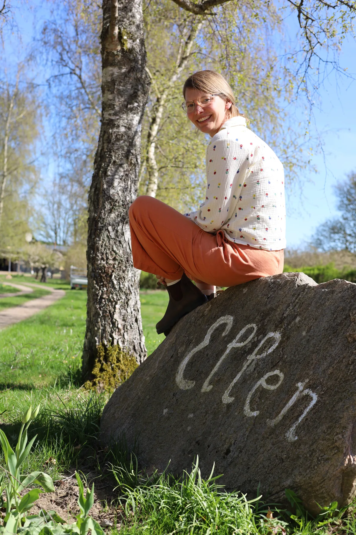 Ilona sitting on the Ellen rock at Ellen Reiki in Sindal, Denmark